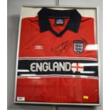 An England international football jersey signed by Malcolm McDonald