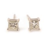 A pair of princess cut diamond stud earrings,