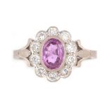 A pink sapphire and diamond cluster ring