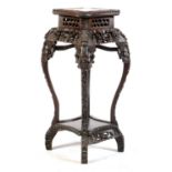 A Chinese carved hardwood jardiniere stand