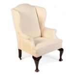 A 19th Century wing back armchair with arched back