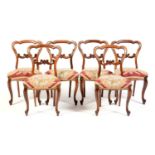 A set of six Victorian carved rosewood balloon back dining chairs