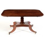 An early 19th Century mahogany and banded tilt action dining table, probably Irish.
