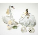 A selection of three Lladro figures and two Swarovski hedgehogs