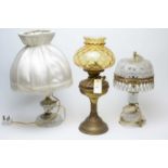 An early 20th C brass oil lamp and two others
