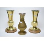 A pair of brass vases and another