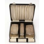 A George V cased silver brush set.