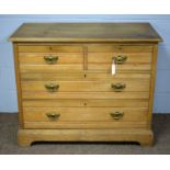 A late Victorian light oak chest of drawers