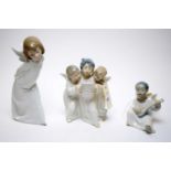 A Lladro figure group of three angels and two other Lladro angel figures