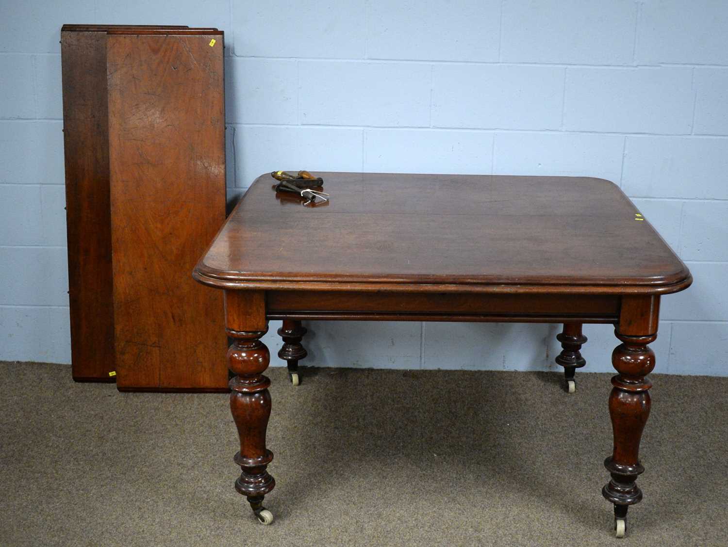 A Victorian mahogany wind-out extending dining table