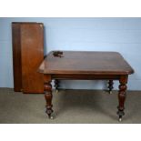 A Victorian mahogany wind-out extending dining table