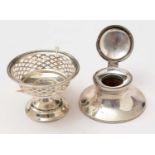 An Edwardian silver bon bon dish and a George V silver capstan inkwell.