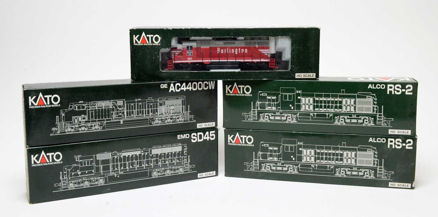 Five Kato HO-gauge boxed trains.