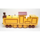 A scratch-built sit-on wooden locomotive with wheels.