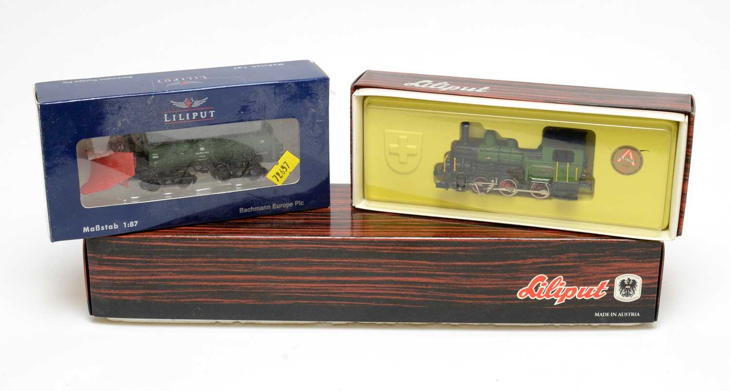 Three boxed Liliput locomotives and rolling stock.