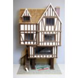 A three-storey Tudor-style doll's house.