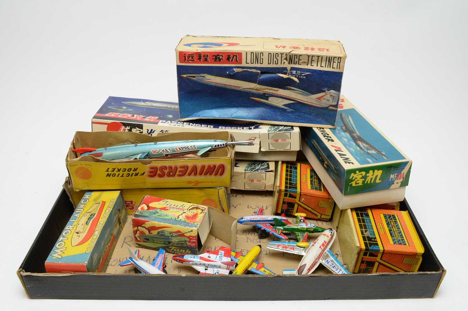 A quantity of boxed and unboxed scale model tinplate aircraft.
