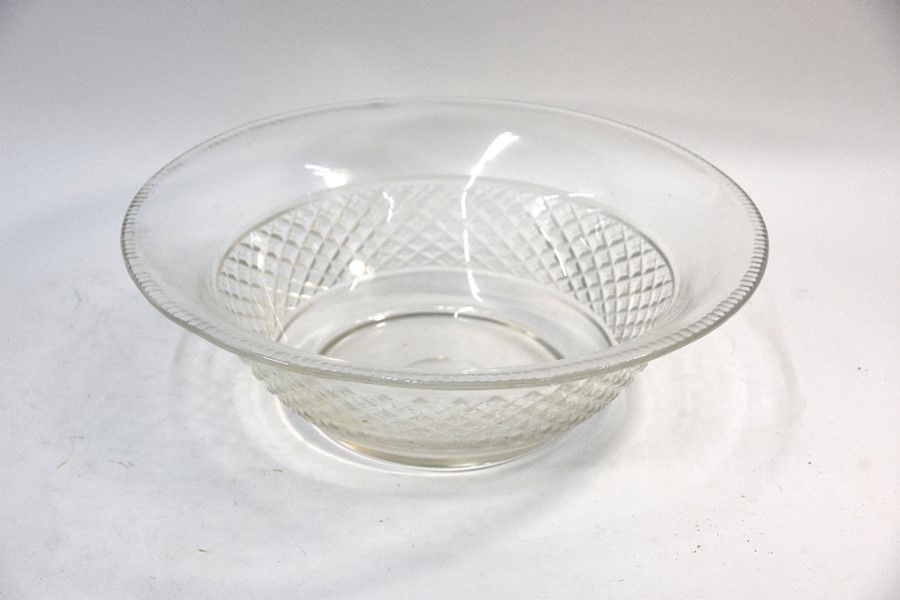 A large cut glass bowl with hobnail and milled edge designs