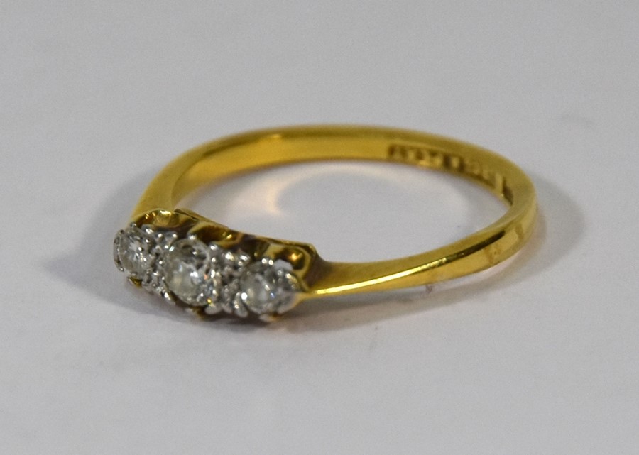 A three stone diamond claw set ring