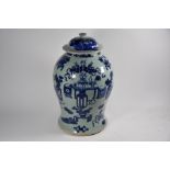 A Chinese blue and white celadon ground 'Hundred Antiques' pattern jar and cover