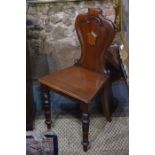 A Victorian mahogany moulded shield back hall chair