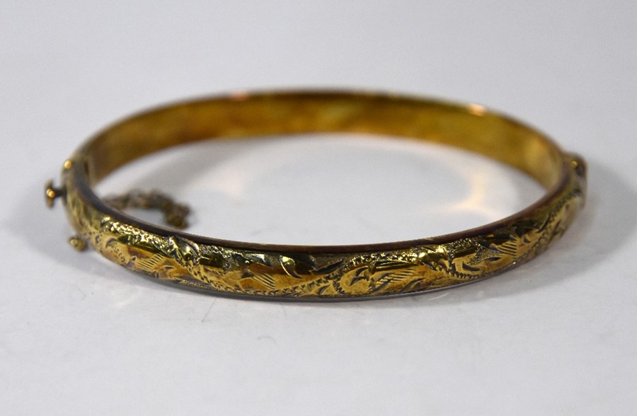 A silver-gilt half hinged bangle with foliate chasing - Image 4 of 4