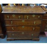 An 18th century oak chest of two over three long graduated drawers