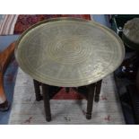 An old Eastern circular engraved brass tray top table