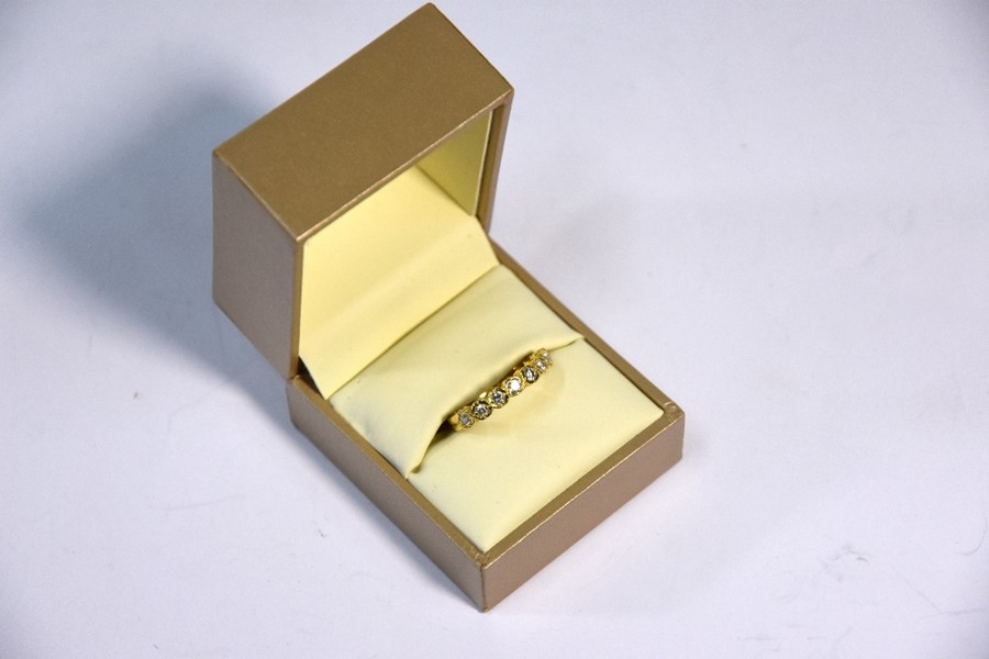 An 18ct yellow gold diamond set half eternity ring