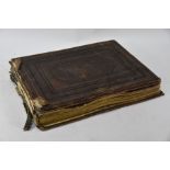 A Victorian leather folio album containing large photographs of prints