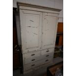 An antique cream painted mahogany linen press