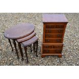 A miniature yew wood chest on chest and nest of tables