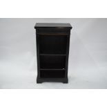 A small carved and ebonised open bookcase