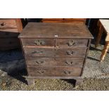 An antique oak chest or two short over three long graduating drawers