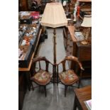 A pair of Edwardian mahogany corner chairs and a standard lamp