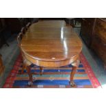 A late Victorian mahogany wind out dining table