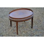 A mahogany oval tray-top butlers table