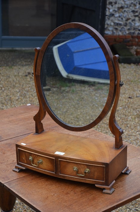 An Edwardian mahogany framed oval toilet mirror