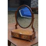 An Edwardian mahogany framed oval toilet mirror