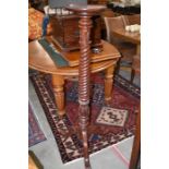 A mahogany jardiniere stand with circular top