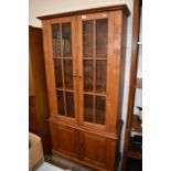A stained teak two section bookcase cabinet,