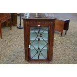 A 19th century inlaid mahogany hanging corner cupboard