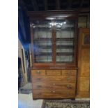 A 19th century mahogany and satin strung bookcase on chest