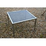 A contemporary square chromed coffee table