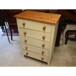 A modern pine cream painted chest of five long drawers