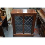 A small mahogany bookcase with leaded glazed doors