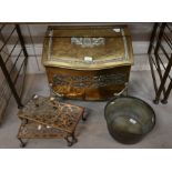 An antique brass serpentine front coal box