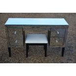 A contemporary mirrored dressing table and stool
