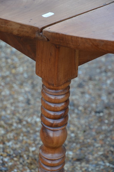 A 19th century fruitwood drop leaf table on turned supports - Image 3 of 3