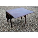 A 19th century mahogany drop leaf dining table